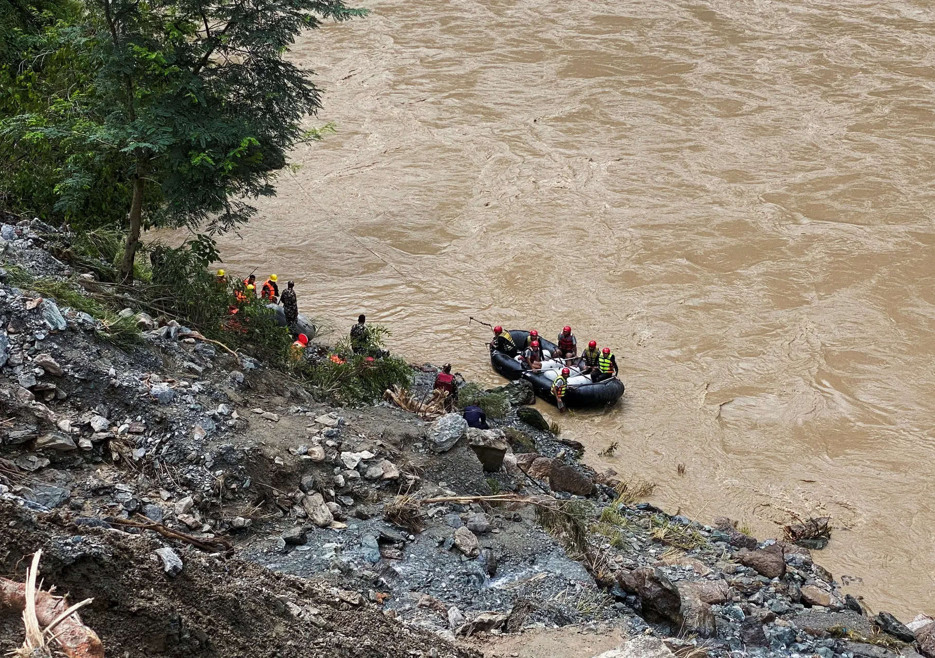 Search for dozens missing after landslide sweeps buses into Nepal river is suspended 