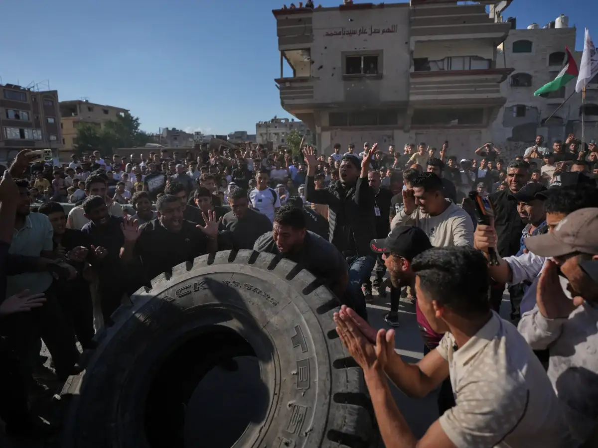 For a day, Gaza’s shouts are shouts of joy: Burly men pull trucks and flip tires in competition of strength 