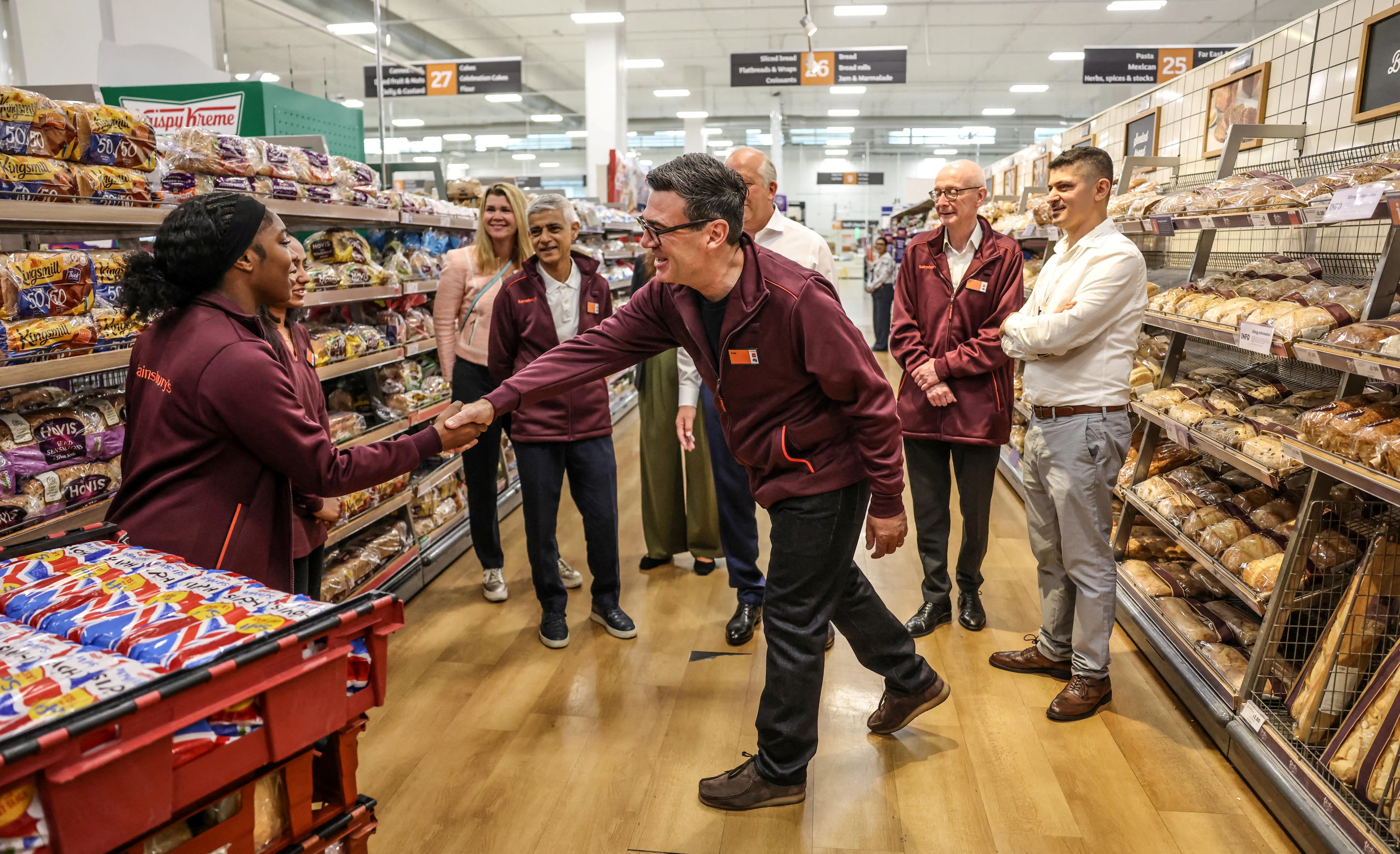 FILE PHOTO: Britain's Prime Minister Andy Burnham talks with staff during a visit to a Sainsbury’s store