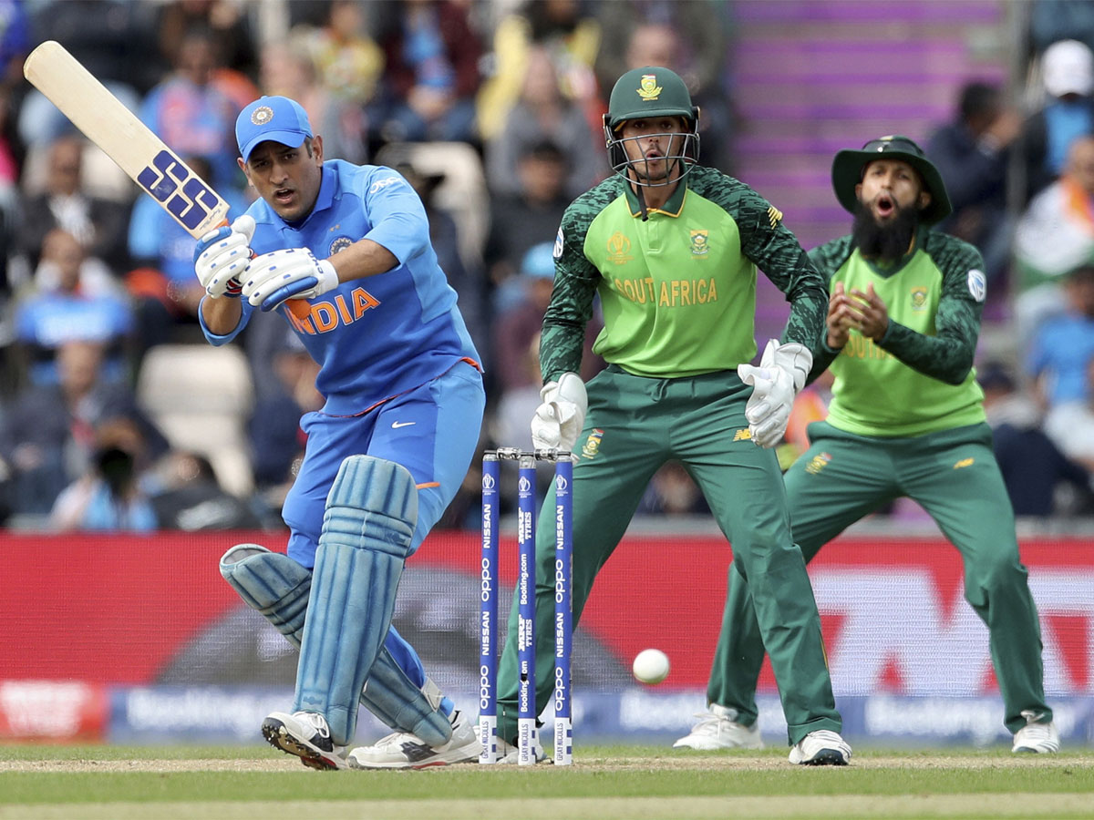 India's MS Dhoni, left, plays a shot during the Cricket World Cup matc...