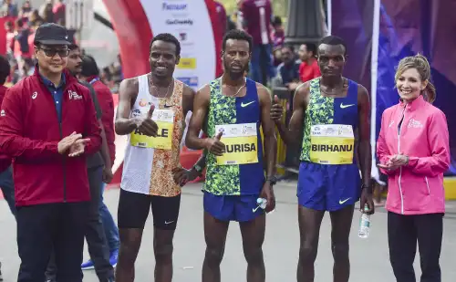Mumbai: Sports Minister Kiren Rijiju (L) along with the winners, gold medallist Derara Hurisa (C), silver medal winner Ayele Abshero (2nd L) and bronze medal winner Birhanu Teshome during the Tata Mumbai Marathon 2020. Mumbai: Sports Minister Kiren Rijiju (L) along with the winners, gold medallist Derara Hurisa (C), silver medal winner Ayele Abshero (2nd L) and bronze medal winner Birhanu Teshome during the Tata Mumbai Marathon 2020.