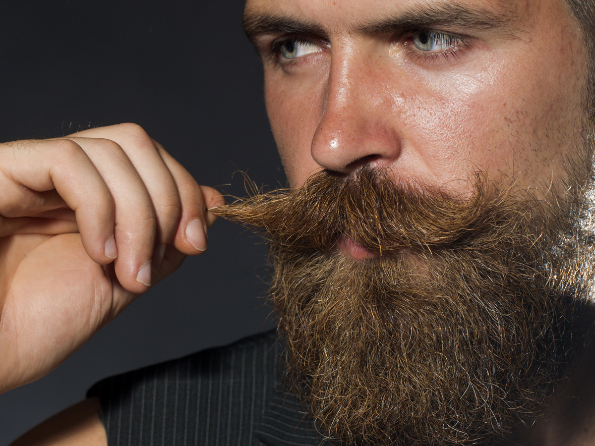 Comb and re-shape the ends of your moustache by twisting the edges around y...