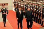 Kim, Xi break the ice with wine and secret pageantry