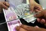 Rupee touches 74.27 against US Dollar