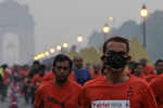 Thousands of runners compete in smoggy Delhi half marathon