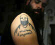 Iraqis seek tattoos to cover scars of war