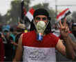 In buckets and gardening gloves, Iraqis dress for tear gas