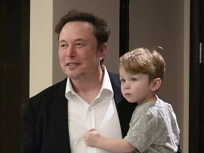 File photo of April 18, 2023​: ​Elon Musk carried his son X after his speech at the POSSIBLE marketing conference in Miami Beach.