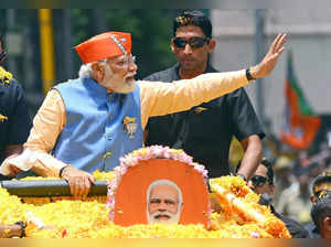 Prime Minister Narendra Modi waves at supporters and party workers during a roadshow ahead of Karnataka Assembly elections, in Bengaluru, Saturday, May 6, 2023. (Photo: Dhananjay Yadav/IANS)