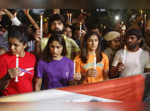 New Delhi: Wrestlers Bajrang Punia, Vinesh Phogat, Sangeeta Phogat, Sakshi Malik and others take out a Candle light march during their protest at Jantar Mantar, in New Delhi, Sunday, May 7, 2023. (Photo: Wasim Sarvar/IANS)