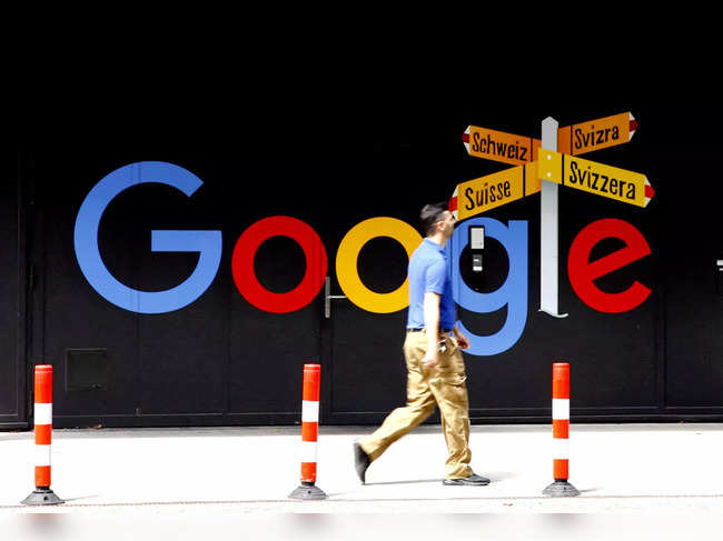 FILE PHOTO: A man walks past a logo of Alphabet Inc's Google in Zurich