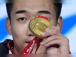 Beijing: Gao Tingyu of China holds up his gold medal during the medal ceremony f...