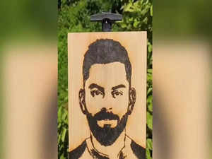 Artist impresses netizens by creating Virat Kohli’s potrait with sunlight and wood, watch viral video