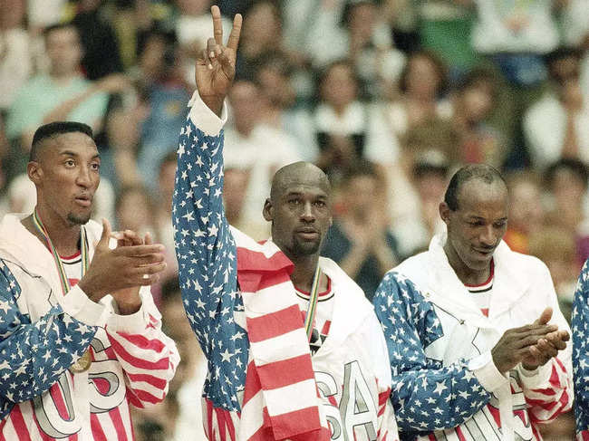 FILE - United States' Scottie Pippen, left, Michael Jorden, center, and Clyde Drexler rejoice, Aug. 8, 1992, with their gold medals after beating Croatia, 117-85, in Olympic basketball in Barcelona, Spain. The jacket that Jordan famously wore but covered the Reebok logo of at the 1992 Barcelona Olympics will be offered at auction by Sotheby's in June 2023. (AP Photo/Susan Ragan, File)