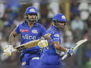 Mumbai: Mumbai Indians batters Suryakumar Yadav and Vishnu Vinod run between the...