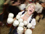 A waitress carries 1-litre beer mugs at the opening of Oktoberfest in Munich