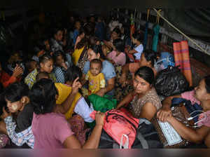 People evacuate on a truck in Sittwe in Myanmar's Rakhine state on May 13, 2023, ahead of the landfall of Cyclone Mocha. Cyclone Mocha is expected to make landfall on May 14 between Cox's Bazar in Bangladesh, where nearly one million Rohingya refugees live in camps largely made up of flimsy shelters, and Sittwe on Myanmar's western Rakhine coast. (Photo by SAI Aung MAIN / AFP)