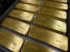 Gold prices flat as steady dollar counters economic risks