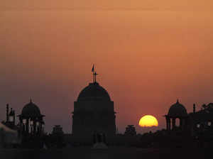 The sun sets in the backdrop of Rashtrapati Bhavan, in New Delhi. (PT...