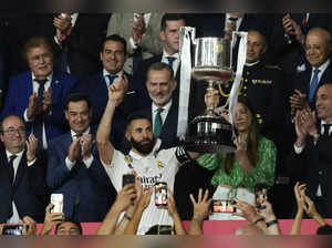 Real Madrid's captain Karim Benzema lefts the trophy in front of Spain's King Fe...