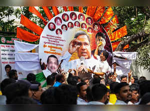 Bengaluru: Supporters of senior Congress leader Siddaramaiah celebrate outside h...