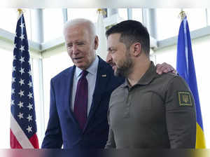 President Joe Biden, left, walks with Ukrainian President Volodymyr Zelenskyy ah...