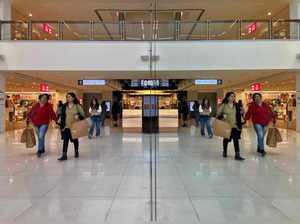 FILE PHOTO: Shoppers are reflected in mirror inside a shopping mall in New Delhi