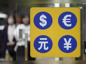 Seoul: People walk near a sign of foreign currency outside a money exchange offi...