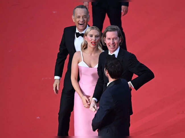 (From L) US actor Tom Hanks, US actress Scarlett Johansson, US director Wes Anderson and US actor Jason Schwartzman wave as they arrive for the screening of the film "Asteroid City" during the 76th edition of the Cannes Film Festival in Cannes, southern France, on May 23, 2023. (Photo by Antonin THUILLIER / AFP)