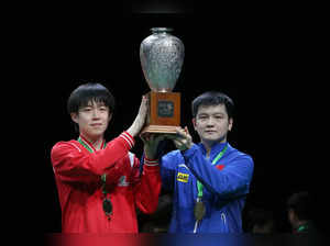 Gold medallists China's Wang Chuqin (L) and China's Fan Zhendong (R) hold the trophy following the men's doubles table tennis final match at the 2023 ITTF World Table Tennis Championships Finals in Durban on May 27, 2023. (Photo by PHILL MAGAKOE / AFP)