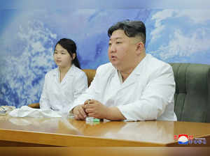 This picture taken on May 16, 2023 and released by North Korea's official Korean Central News Agency (KCNA) on May 17, 2023 shows North Korean leader Kim Jong Un (R) and his daughter, presumed to be named Ju Ae, meeting with the Non-permanent Satellite Launch Preparatory Committee before inspecting a military reconnaissance satellite, at an undisclosed location in North Korea. Kim Jong Un has inspected North Korea's first military spy satellite and gave the go-ahead for its "future action plan," state media said on May 17. -  - South Korea OUT / ---EDITORS NOTE--- RESTRICTED TO EDITORIAL USE -