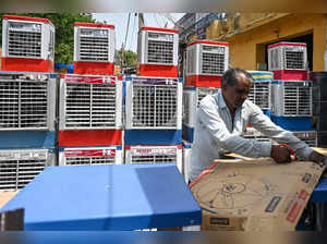 A worker packs an air-cooler for delivery after a sale, at a market on a hot summer afternoon in New Delhi on May 23, 2023.    (Photo by Arun SANKAR / AFP)