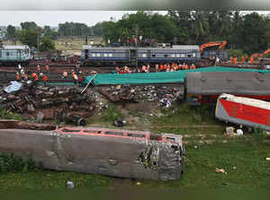 Railway workers help to restore services at the accident site of a three-train collision near Balasore, about 200 km (125 miles) from the state capital Bhubaneswar in the eastern state of Odisha, on June 4, 2023. Railway teams worked non-stop on June 4 restoring tracks after India's deadliest train crash in decades, a tragedy that has reignited safety concerns about one of the largest networks in the world. (Photo by Punit PARANJPE / AFP)