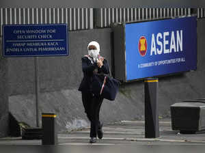 A woman walks past a sign of the Association of Southeast Asian Nations (ASEAN) ...