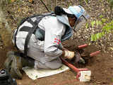 Woman deminer digs out a landmine in Sri Lanka