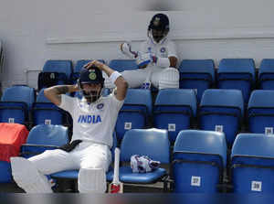 India's Virat Kohli, front and teammate India's Ajinkya Rahane wait for the star...