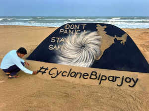 Puri: Sand artist Sudarsan Pattnaik creates a sand sculpture on Cyclone Biparjoy...
