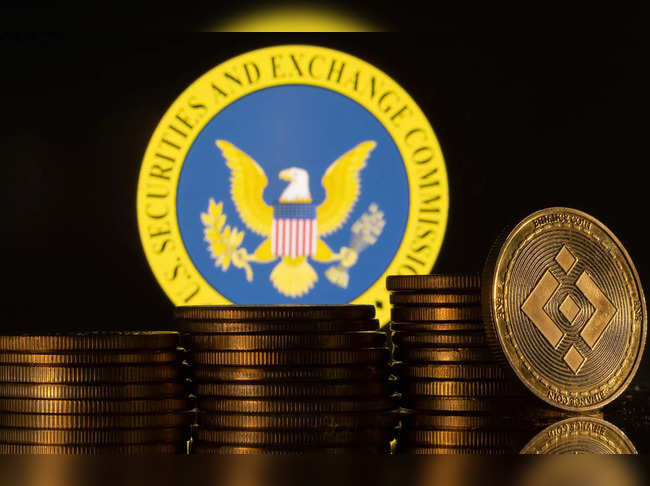 Illustration shows U.S. Securities and Exchange Commission logo and representations of cryptocurrency Binance