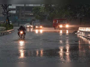 New Delhi: A vehicle moves through waterlogged road during rain, in New Delhi. (...