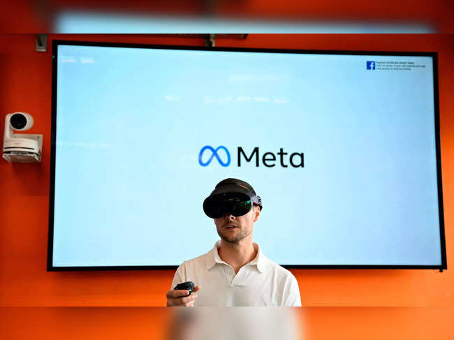 A volunteer wears virtual reality (VR) glasses during a launch event at the corporate offices of Meta in Berlin on June 6, 2023. (Photo by Tobias SCHWARZ / AFP)