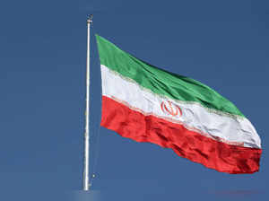 The Iranian flag is seen flying over a street in Tehran