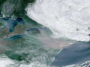This National Oceanic and Atmospheric Administration (NOAA) satellite handout image shows smoke (C) from Canada's wildfires over the the US East Coast,  on June 7, 2023 at 18:10UTC . Canadian wildfires that have produced a blanket of smog in cities along the US East Coast are an "alarming example of the ways in which the climate crisis is disturbing our lives," the White House said on June 7. - RESTRICTED TO EDITORIAL USE - MANDATORY CREDIT "AFP PHOTO / RAMMB/NOAA" - NO MARKETING NO ADVERTISING CAMPAIGNS - DISTRIBUTED AS A SERVICE TO CLIENTS (Photo by Handout / AFP) /