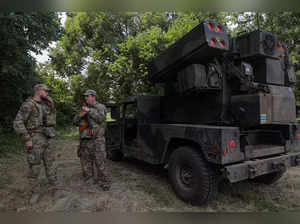 Ukrainian servicemen stand next to an AN_TWQ-1 Avenger mobile air defence missile system outside of Kyiv.