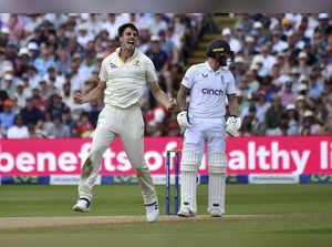 Australia captain Pat Cummins, left, celebrates taking the wicket of England cap...