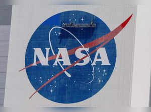 Workers pressure wash the logo of NASA on the Vehicle Assembly Building, in Cape Canaveral.
