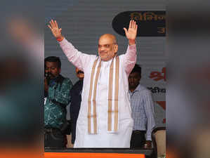Jammu: Union Home Minister Amit Shah waves at supporters during a public meeting...