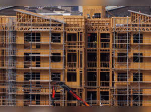 FILE PHOTO: Construction workers build multifamily housing in California