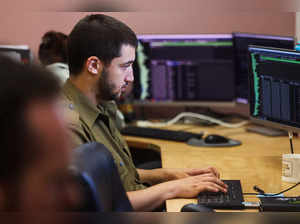 Technologists with the Israeli military's Matzpen operational data and applications unit work at their stations at an IDF base in Ramat Gan