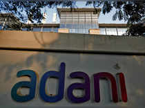 FILE PHOTO: The logo of the Adani Group is seen on the wall of its realty office building on the outskirts of Ahmedabad