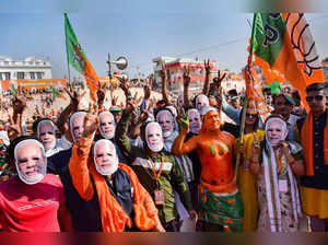 Agartala: BJP supporters wearing PM Modi face masks attend an election campaign ...
